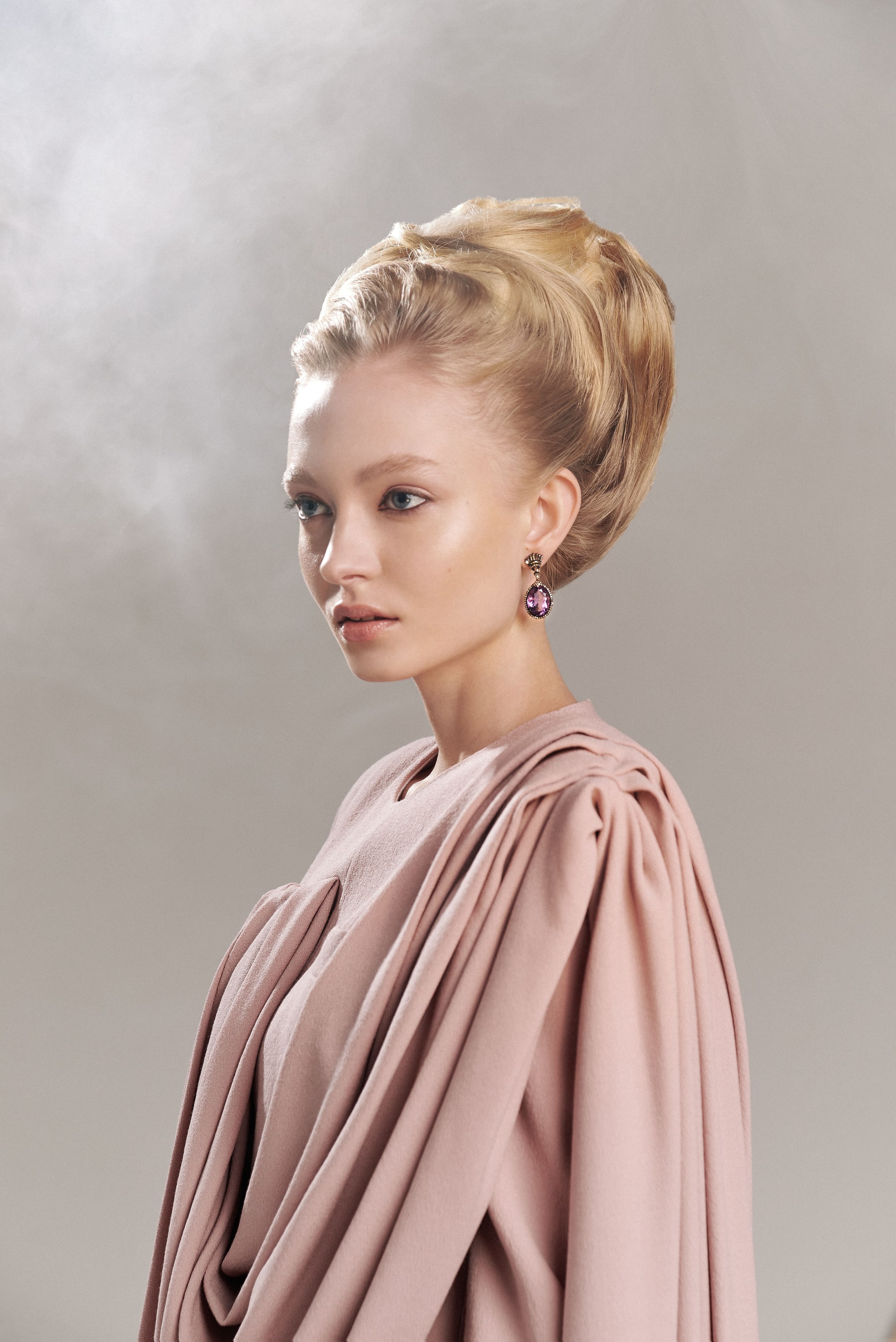 Nikita Lauffer in profile, in a draped dress with her hair up