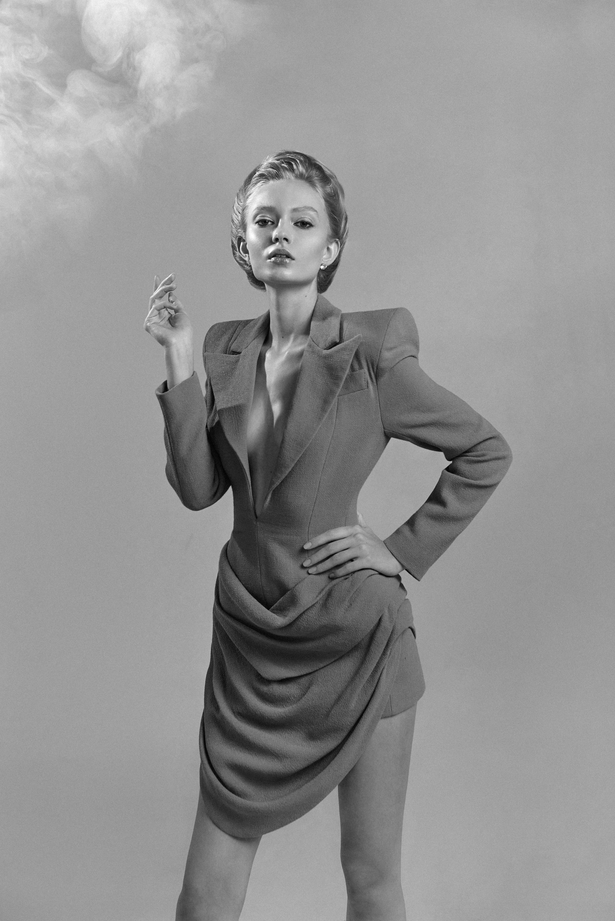 Nikita Lauffer in a tailored blazer dress under a cloudy sky