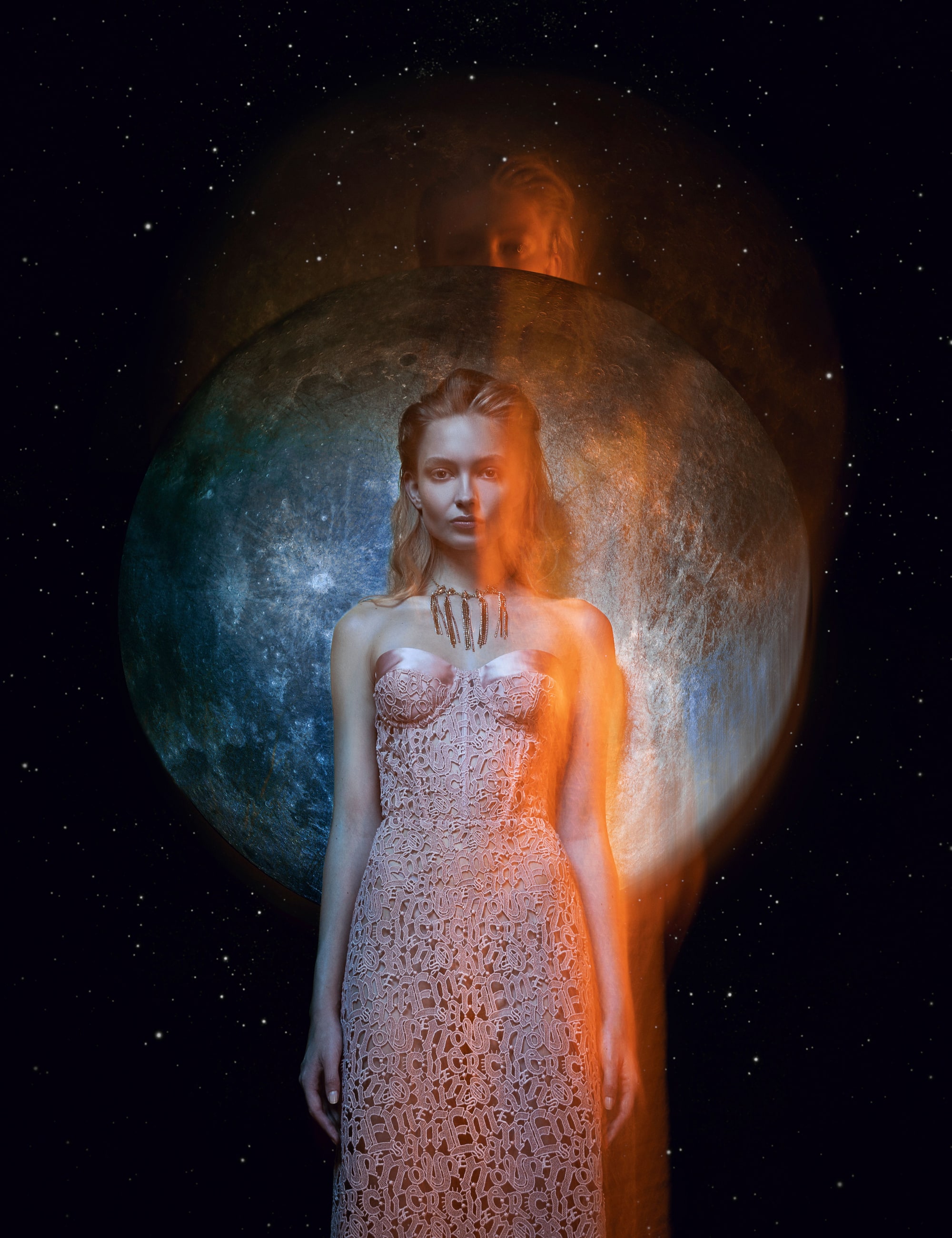 Nikita Lauffer in a lace dress in front of a blue moon, with orange light trails